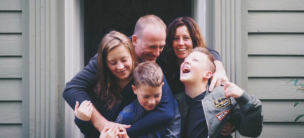 Happy family in front of their inspected home